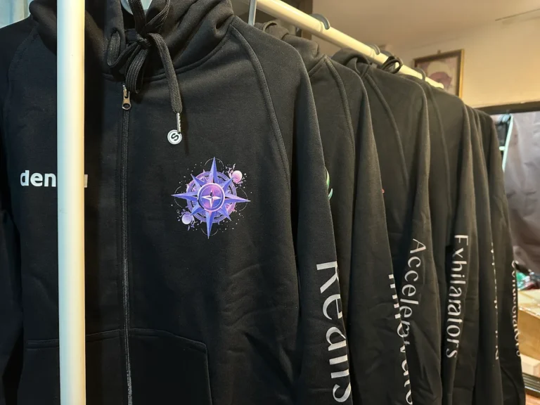 Rack of custom black team hoodies with sleeve prints