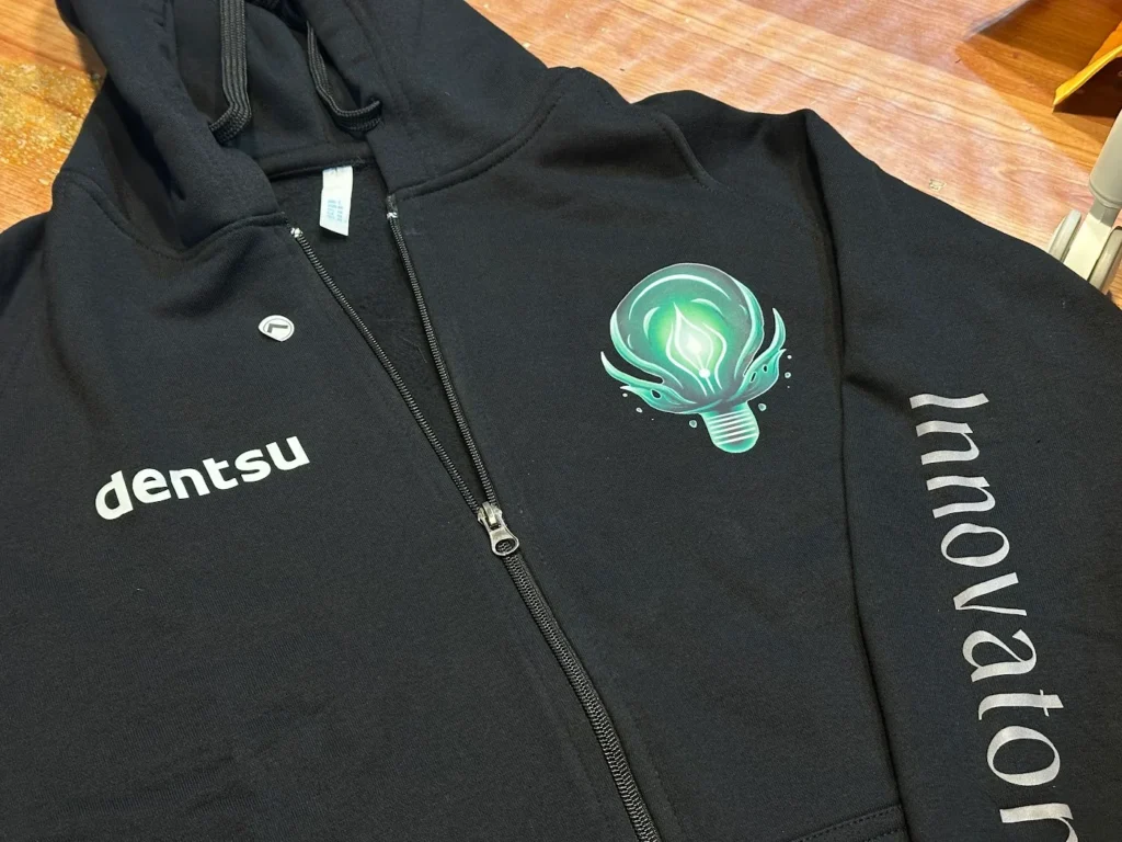 Black zip hoodie with embroidered chest logo made for Dentsu