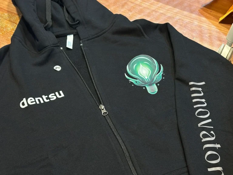 Black zip hoodie with embroidered chest logo made for Dentsu