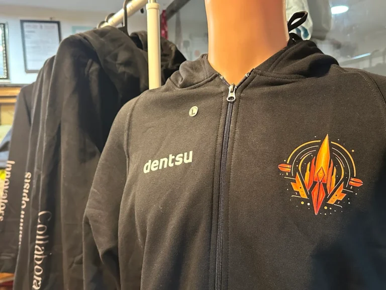 Close-up of embroidered logo on a black hoodie