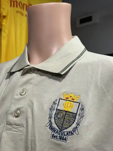 Beige school polo with multicolour embroidered crest