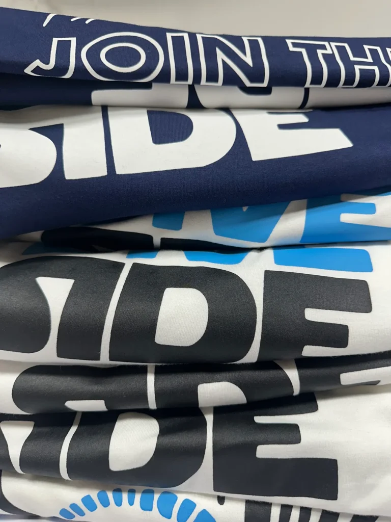 Stack of custom printed t-shirts ready for dispatch
